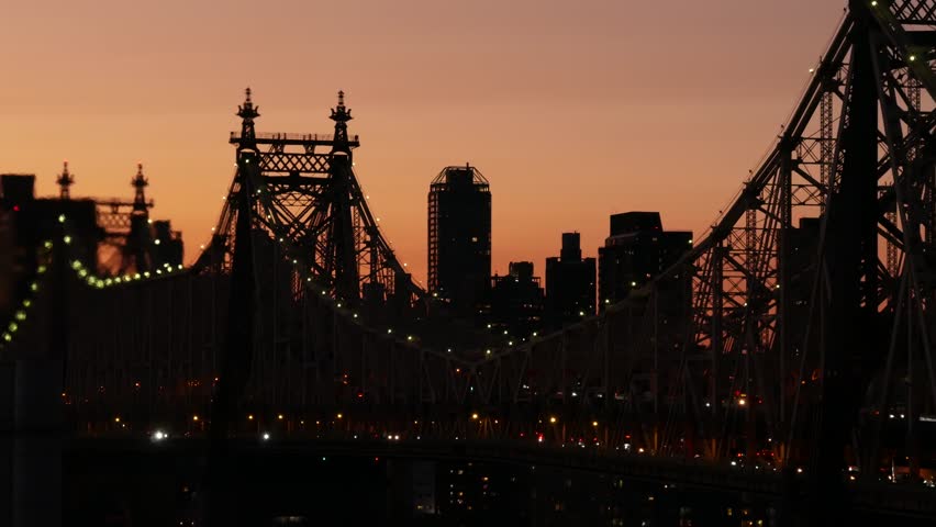 New York City Manhattan Midtown skyline from Queens, Queensboro bridge architecture, United States. Rooftop cityscape from Long Island Hunters Point. Urban sunset twilight dusk dark evening silhouette