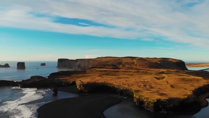 Dramatic aerial view of a vast desert canyon and volcanic rock formations under a clear sky. Rugged wild nature and geological exploration.