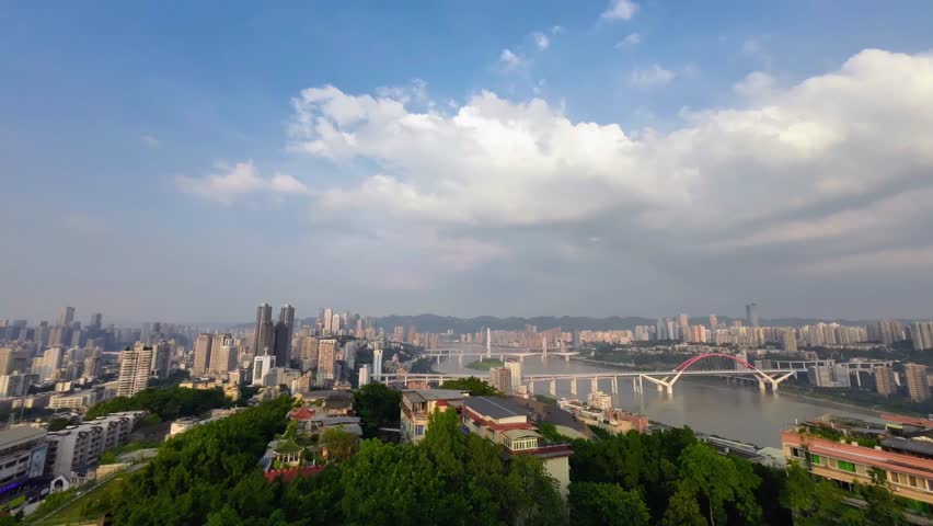 Timelapse cityscape of Chongqing China with dramatic clouds moving rapidly above dense urban skyline. Dynamic megacity atmosphere and architectural growth in southwestern China.