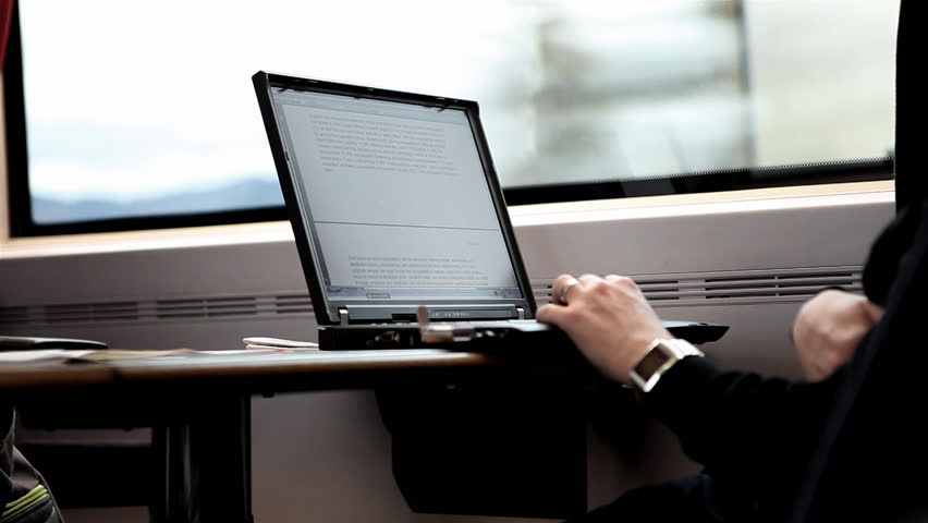 A Person is working with its Laptop during a train ride / HD1080 / 30fps