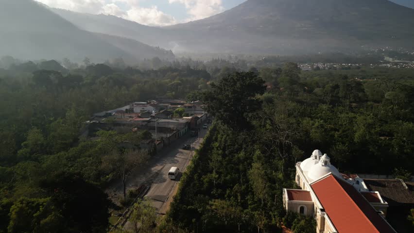 Aerial of rural farms in Antigua Guatemala reveal to volcano Volcan de Agua