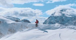 Aerial footage of a ski mountaineer ascending a snowy alpine ridge in Dolomites. Winter landscape, backcountry adventure, and solitude in breathtaking mountain scenery captured in 4K. - Powered by Shutterstock - Get 15% off with code: PIKWIZARD15