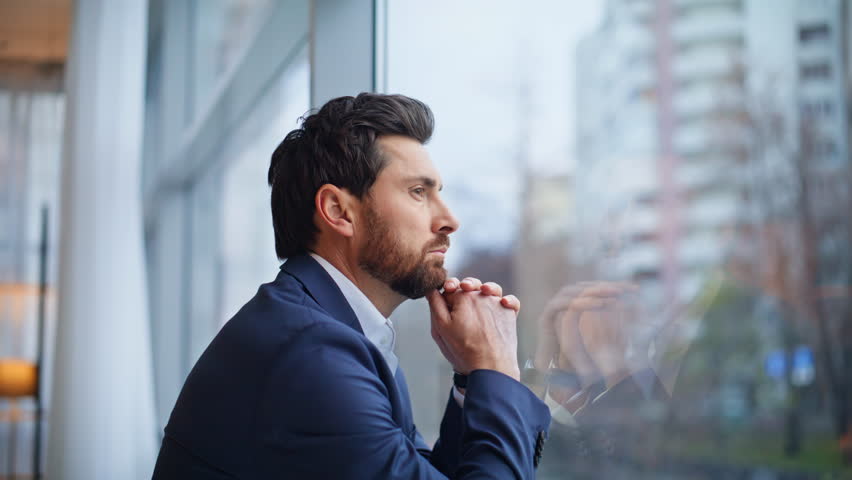 Nervous manager looking cityscape standing office room closeup. Pensive businessman staring city making company decision at panoramic window. Successful corporate leader think enjoy silent break alone