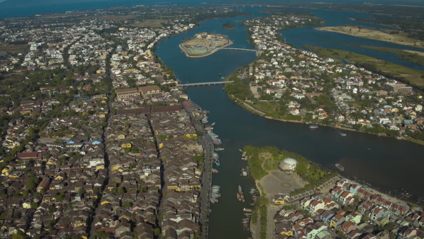 High altitude drone footage flying over the historic city of hoi an in vietnam and its river
