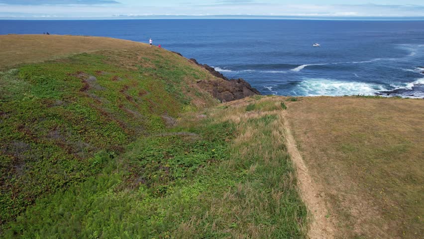 Aerial of Rocky Creek Scenic point in Oregon USA off the Pacific coast.  Slow approach shot of blue rough waters below.  