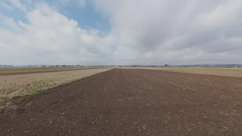 Vast Empty Rice Field with No Crops Planted in Japanese Countryside