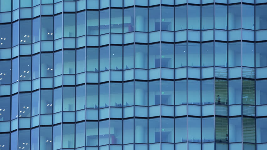 Abstract pattern of a blue glass skyscraper facade in a modern city.