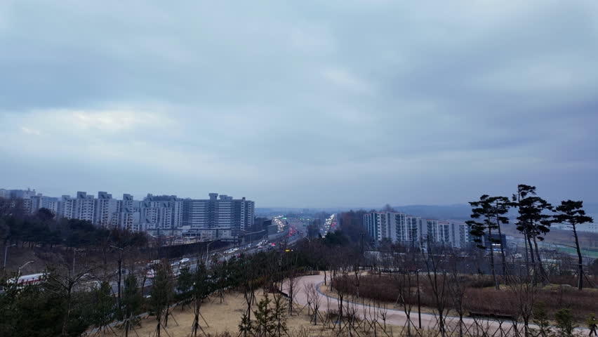 Timelapse of vehicles passing through Moran Tollgate during winter sunrise in Seongnam, South Korea. Early morning traffic flow with changing light conditions.