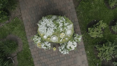 Aerial View of Elegant Garden Table Setting with White Flowers