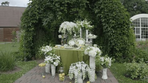 Aerial View of Elegant Floral Table Setting with White Flowers and Greenery