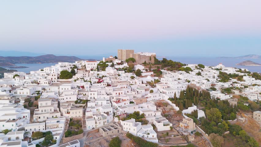 Aerial view of a serene Greek island village at sunrise