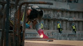 A worker at a construction site welds metal with a welding machine - Powered by Shutterstock - Get 15% off with code: PIKWIZARD15