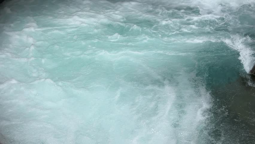 Experience the majestic power of a wild alpine river, with white turbulent water and foamy rapids, flowing in the Austrian Alps during a beautiful summer day, a true natural wonder.