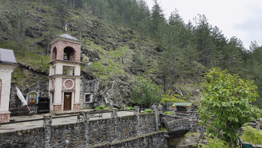 Orthodox church in Bele Vode near Mokra Gora surrounded by forested mountain landscape in spring. Scenic rural Serbia travel and spiritual heritage concept