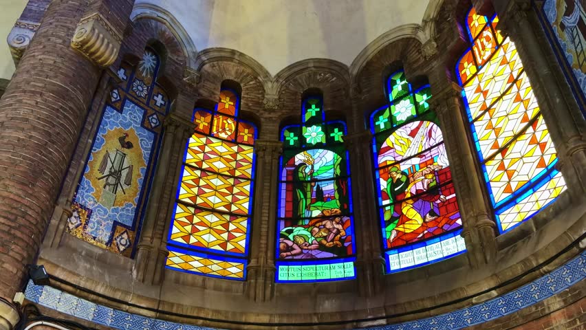 Interior detail of colorful art nouveau stained glass windows in a historic church of Hospital de Sant Pau in Barcelona, Spain. Low-angle pov