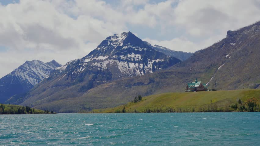 Prince of Wales Hotel overlooking Waterton Lake with mountains in the Canadian Rockies