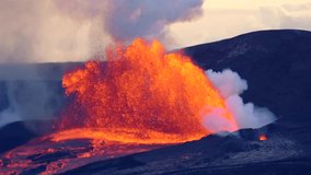 Slow-motion footage of a Hawaiian volcano erupting, molten lava blasting high into the sky as glowing fire and ash light up the landscape in a dramatic natural spectacle. - Powered by Shutterstock - Get 15% off with code: PIKWIZARD15