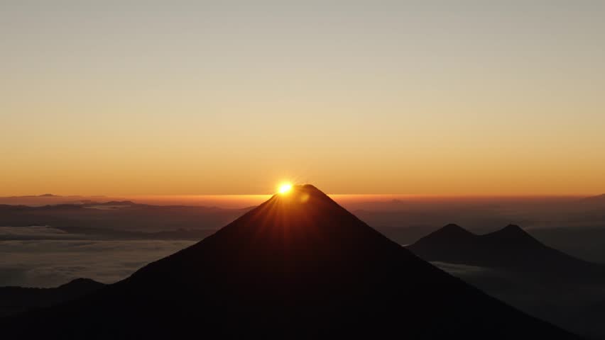 Landscape view of sunrise over Agua Volcano from Acatenango in Guatemala