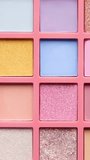 Make-up artist picks up pink pigment from bright colorful eyeshadow palette with a brush. Decorative cosmetics and visage concept. - Powered by Shutterstock - Get 15% off with code: PIKWIZARD15