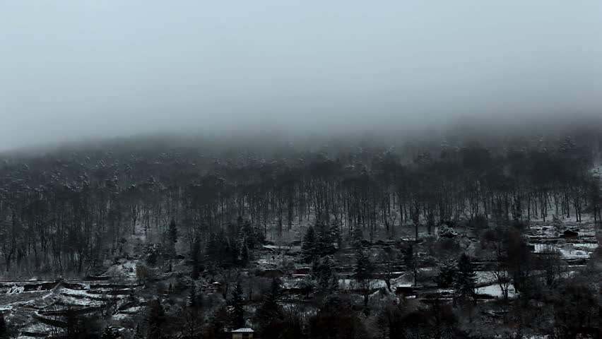Winter landscape with fog passing softly over dark hill / HD1080 / 30fps 