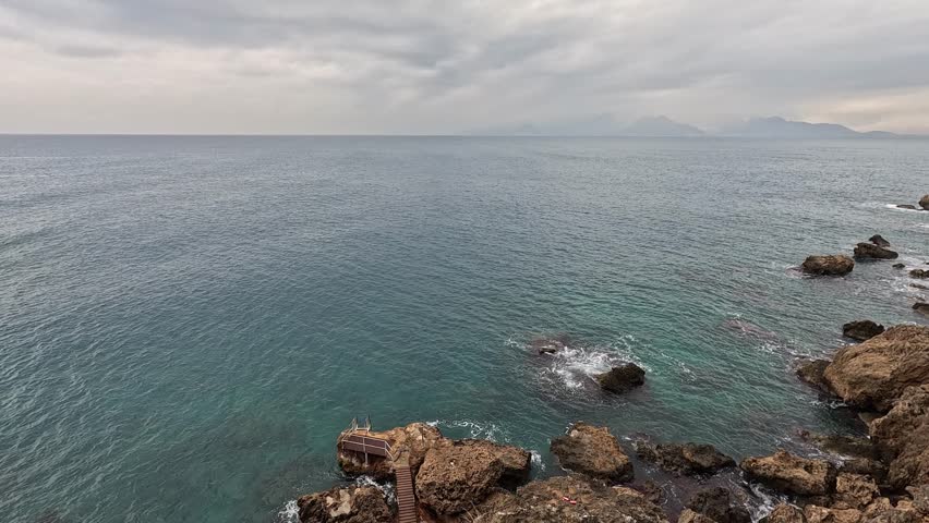 powerful sea waves crashing against rocks on the shore