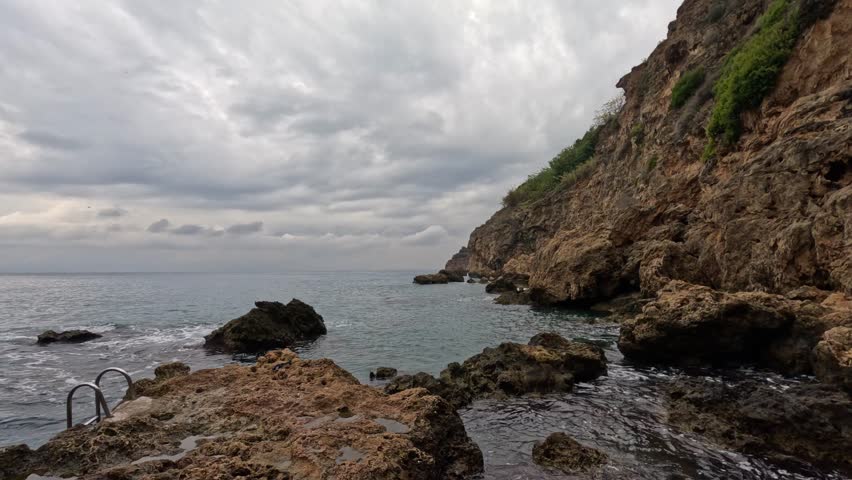 powerful sea waves crashing against rocks on the shore