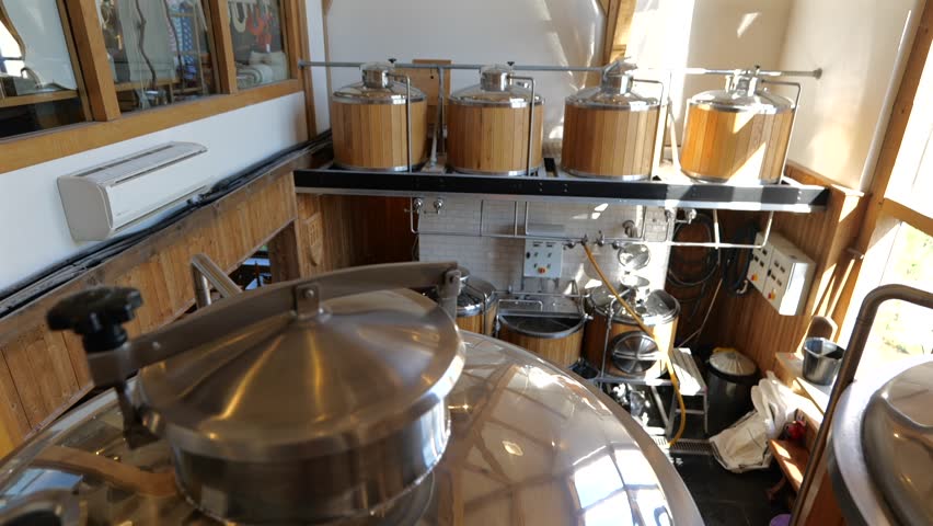 Slide right beer brewery vats, interior with daylight