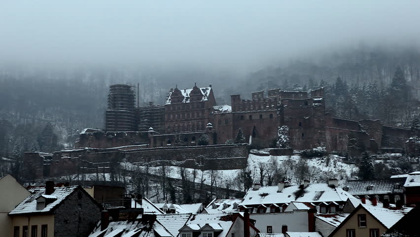 Romantic Scene of a Castle in winter atmosphere with fog and snow laying on
