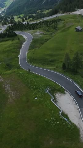 Vertical screen Scenic Valley Journey Through Mountains. Serene Mountain Drive Along Winding Paths And Lush Greenery. Experience Tranquility Of Rolling Hills And Twisting Roads Through Magnificent