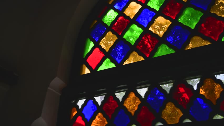 Interior view highlighting stained glass window details and decorative elements inside Bahia Palace in Marrakesh, Morocco