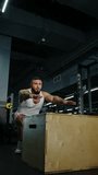 Focused athlete performing explosive box jumps in a modern indoor gym, showcasing lower-body strength, balance, and coordination during an intense plyometric workout session. - Powered by Shutterstock - Get 15% off with code: PIKWIZARD15