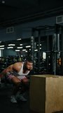 Athletic man performing explosive box jump exercise onto a wooden plyometric box in a modern gym, captured from crouched launch to landing, showcasing strength, balance, agility. - Powered by Shutterstock - Get 15% off with code: PIKWIZARD15