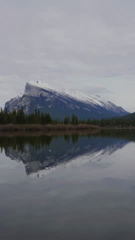 Mount Rundle winter landscape reflecting in a calm Vermilion Lake at Banff National Park in Canada