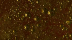 Golden shimmering bubbles float and move slowly within a dark abstract liquid creating a beautiful and dynamic macro background - Powered by Shutterstock - Get 15% off with code: PIKWIZARD15