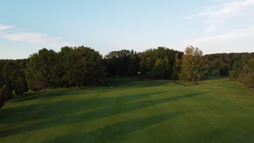 Aerial of Green Bay Wisconsin Golf Course on an evening night.  Drone approach shot of dark green.