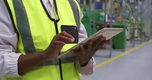 Financial data processing against mid section of engineer using digital tablet at factory. global finance and business technology concept - Powered by Shutterstock - Get 15% off with code: PIKWIZARD15