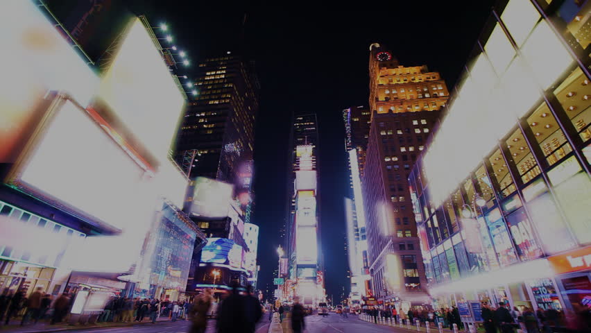 Time Lapse of busy street action on Times Square at night with brands blurred