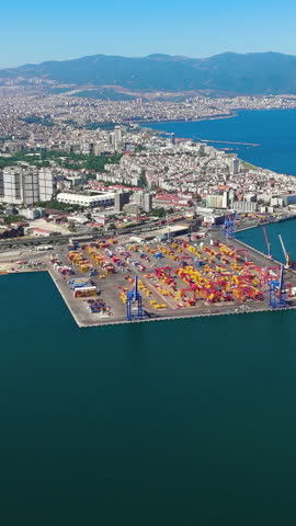 Vertical video. Izmir, Turkey. Aerial panoramic view of Izmir Port with cruise ships and surrounding city panorama including Alsancak district and bay area. Aerial view. Rich colors