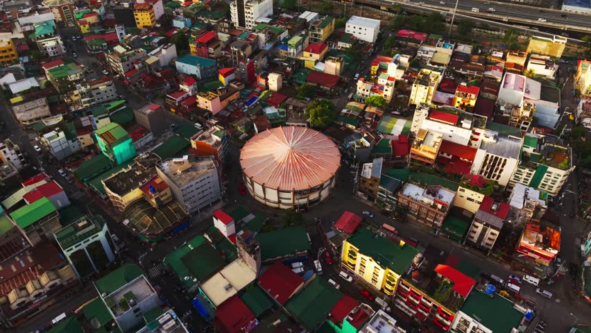 Drone push toward round sports venue in dense Makati district, Pio del Pilar