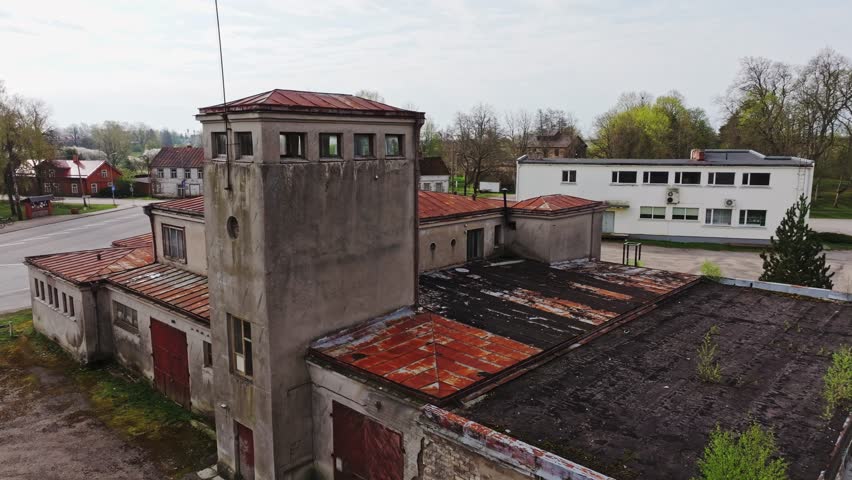 Slow drone orbit reveals Rucava church and quiet crossroads