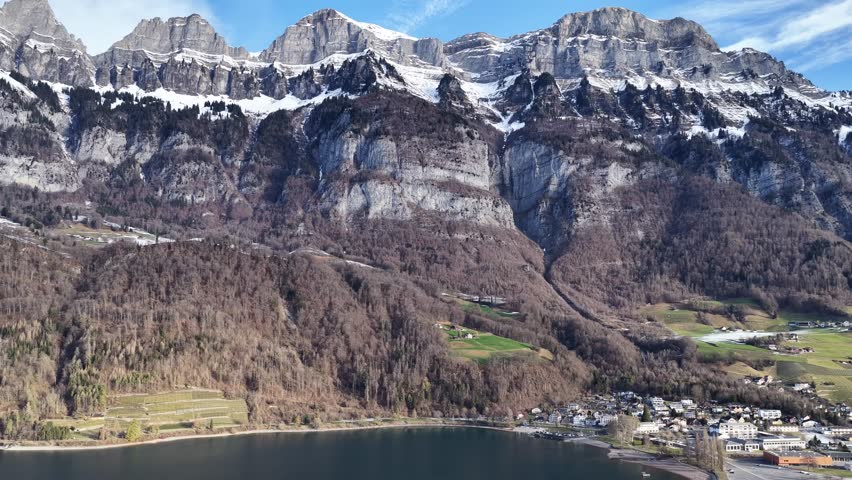 Drone view of Churfirsten cliffs over Walensee lake and Walenstadt town