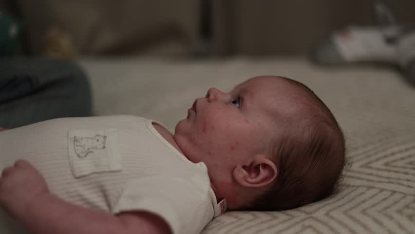 A detailed side view captures a young infant