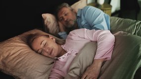Happy middle-aged couple peacefully sleeping embraced in bed, healthy night rest - Powered by Shutterstock - Get 15% off with code: PIKWIZARD15