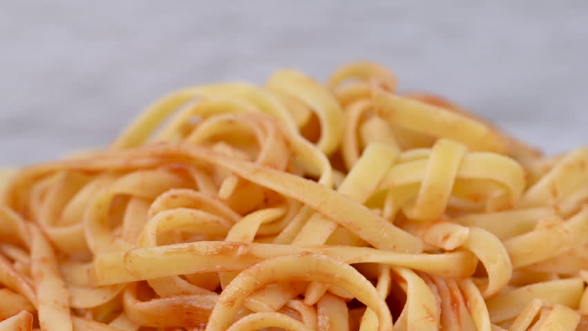 A close-up video of noodles with ketchup