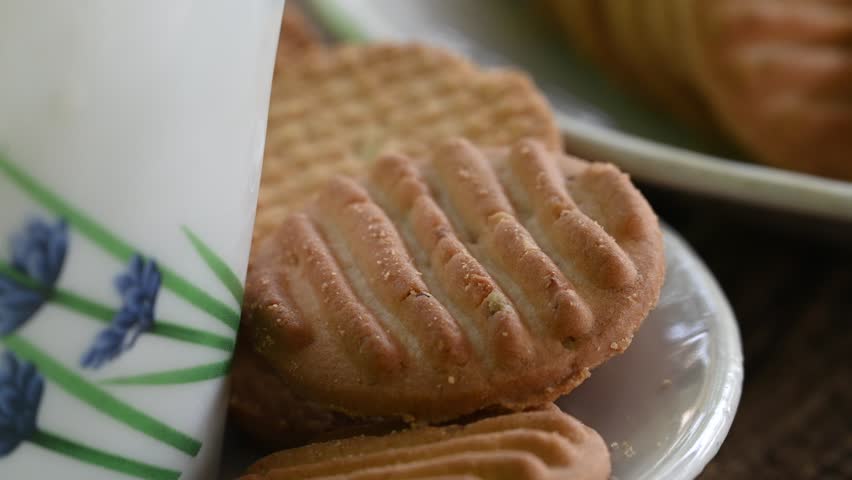 Biscuits and fresh milk on wooden background. a cup of milk and biscuits on a wooden table for a light breakfast.