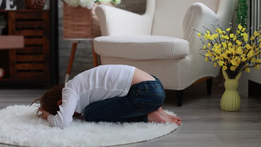 Beautiful preschool child, boy, playing with ducklings at home