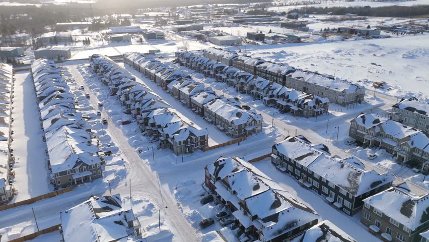 Suburban housing development with snow covered streets in Ontario Canada Aerial