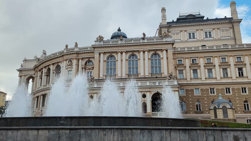 Scenic view of fountain against historic facade of Opera House in city center of Odesa