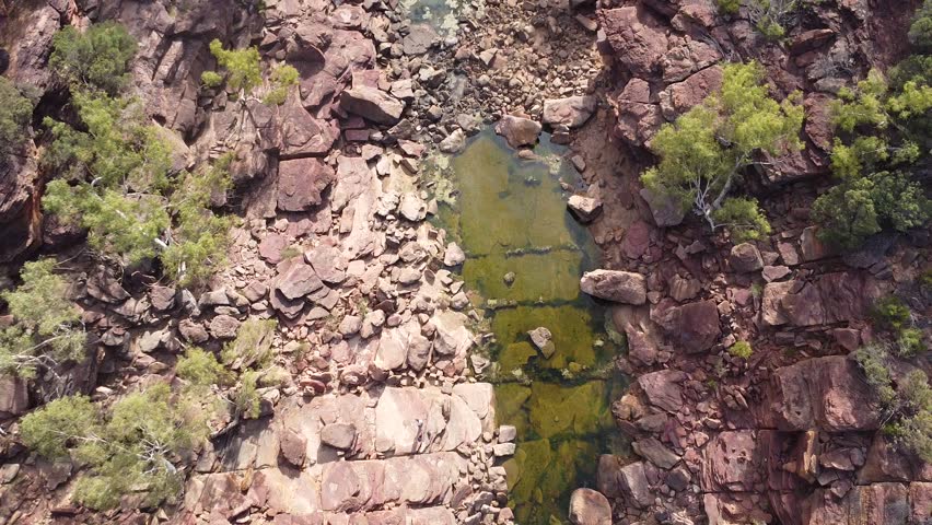 Top down drone shot of rocky riverbed and natural pools in Kalbarri National Park, Western Australia.