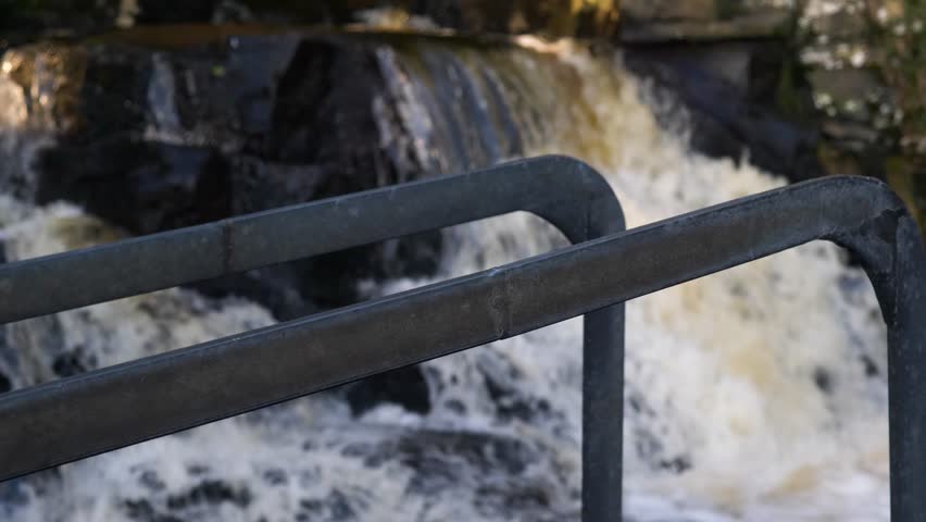 Woman enjoying refreshing cold plunge at Cathole falls, Ireland